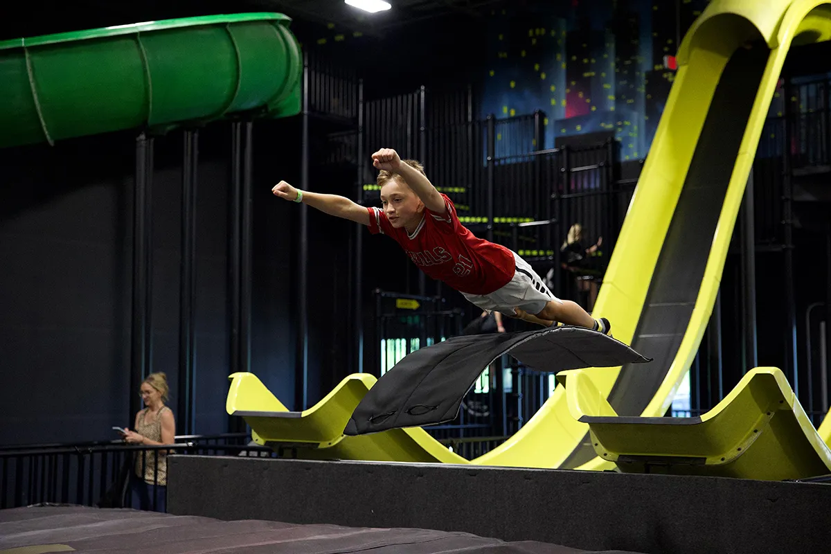 child at the mega launch slide